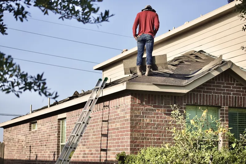 Professional roofer working on a residential roof in Morris